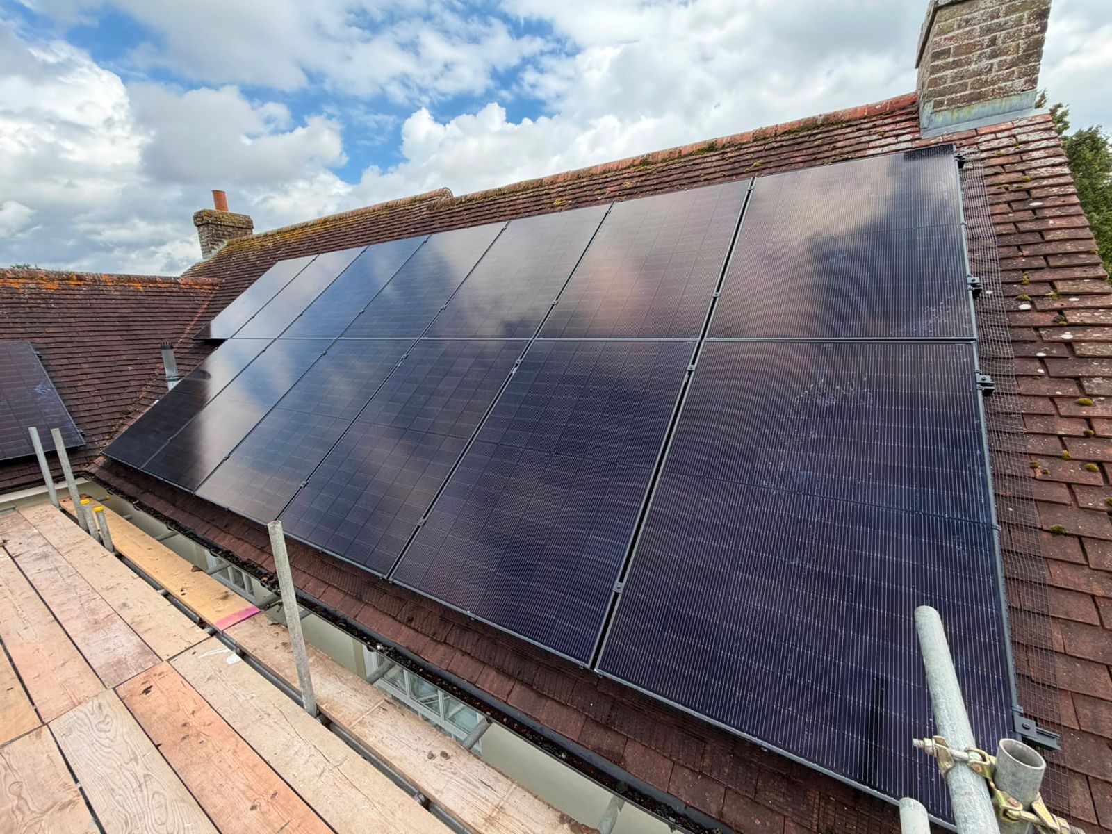 Black solar panels installed on a tiled home roof by GS Solar
